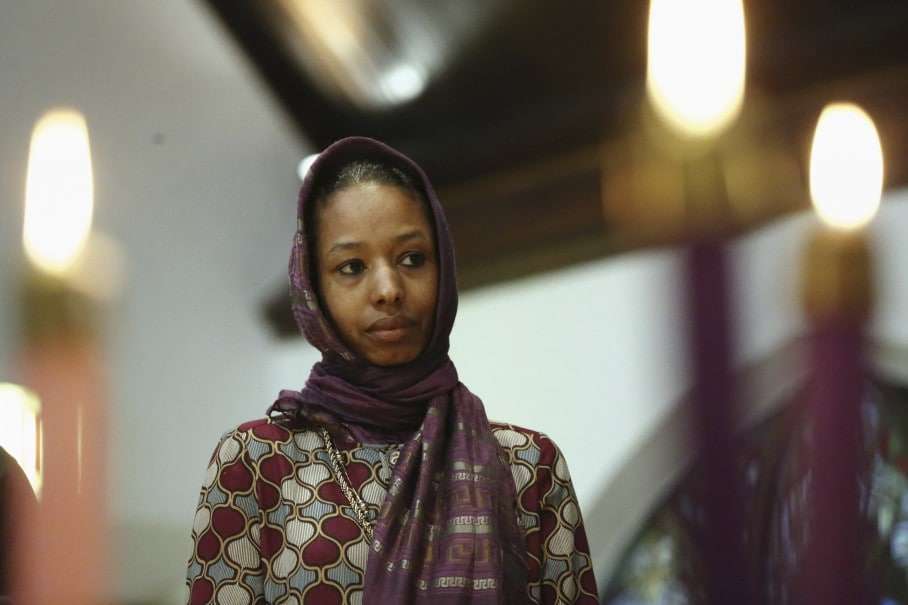 In this Dec. 13, 2015 photo, Larycia Hawkins, a Christian, and an associate professor of political science at Wheaton College, a private evangelical school in Wheaton, Ill., wears a hijab at a church service in Chicago. The school said in a statement Tuesday Dec. 16, 2015, it has Hawkins placed on administrative leave because of statements she made on social media about similarities between Islam and Christianity. (Stacey Wescott/Chicago Tribune via AP)