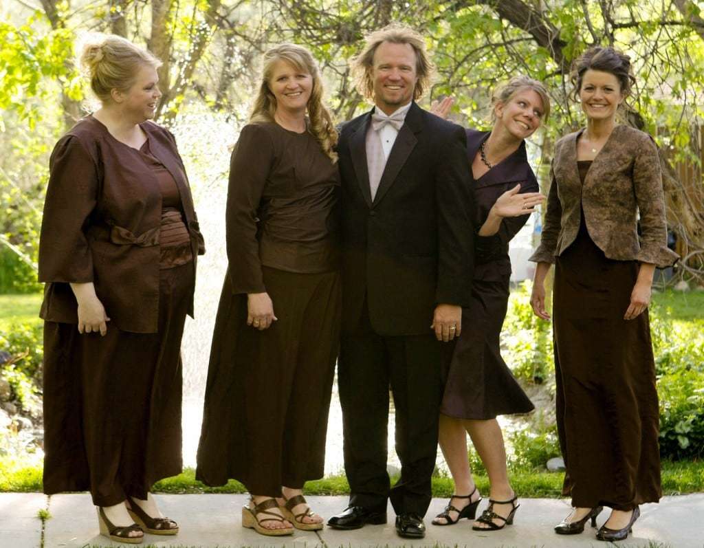 FILE - In this undated file photo provided by TLC, Kody Brown, center, poses with his wives, from left, Janelle, Christine, Meri, and Robyn in a promotional photo for TLC's reality TV show, "Sister Wives." A Utah county attorney says he will not pursue criminal charges against this polygamous family made famous by a reality TV show. Utah County Attorney Jeff Buhman says he has closed the case against Brown and his four wives. (AP Photo/TLC, Bryant Livingston, File)