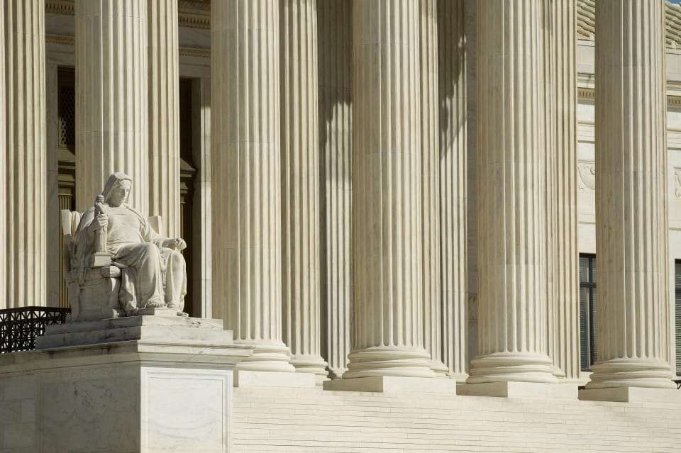 The "Contemplation of Justice" statue sits in front of the Supreme Court building in Washington, D.C., U.S., on Monday, March 26, 2012. The Supreme Court opens today its historic review of President Barack Obama's health-care law, three days of arguments that might result in the president's premier legislative achievement being found unconstitutional in the middle of his re-election campaign. Photographer: Andrew Harrer/Bloomberg