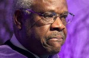 Supreme Court Justice Clarence Thomas pauses while speaking about his time as a student at College of the Holy Cross after receiving an honorary degree from the college, Thursday, Jan. 26, 2012, in Worcester, Mass. (AP Photo/Michael Dwyer)