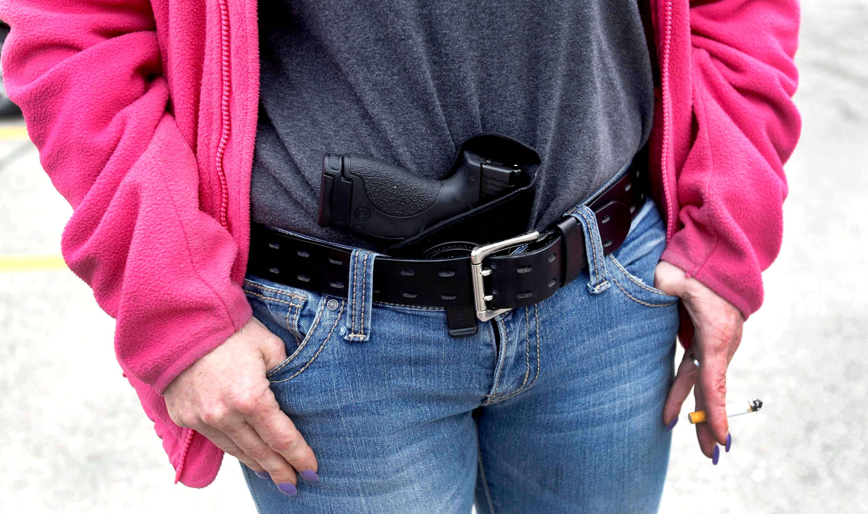 Gloria Lincoln-Thompson carries her 9mm Smith & Wesson pistol in her waist band during a rally in support of the Michigan Open Carry gun law in Romulus, Michigan April 27, 2014. Unlike the subject of this blog post, she was apparently not singing Hakuna Matata at the time. REUTERS/Rebecca Cook (UNITED STATES - Tags: CIVIL UNREST POLITICS SOCIETY TPX IMAGES OF THE DAY)