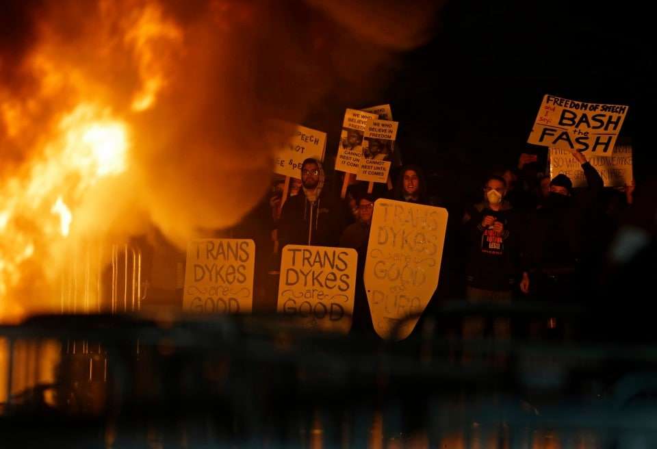 Protestors watch a fire on Sproul Plaza during a rally against the scheduled speaking appearance by Breitbart News editor Milo Yiannopoulos on the University of California at Berkeley campus on Wednesday, Feb. 1, 2017, in Berkeley, Calif. The event was cancelled due to size of the crowd and several fires being set. (AP Photo/Ben Margot)