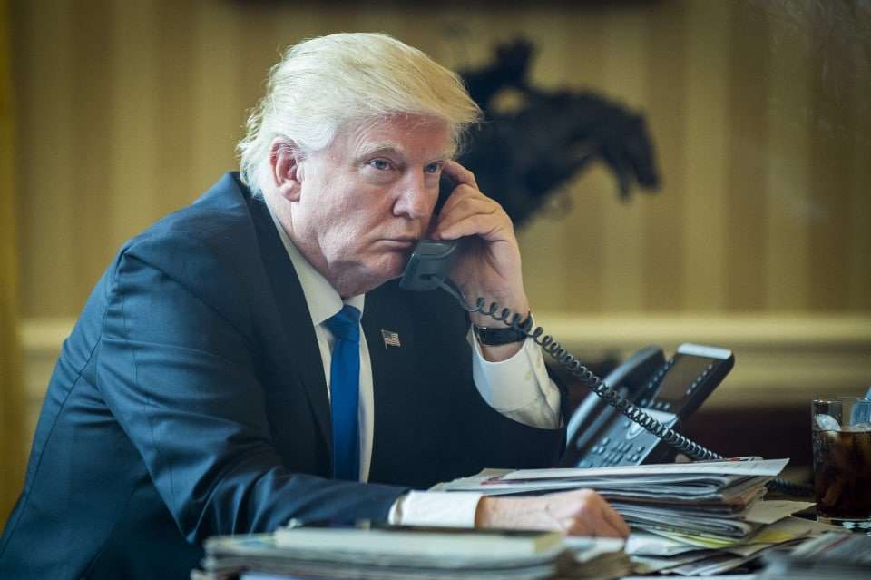 U.S. President Donald Trump speaks on the phone with Vladimir Putin, Russia's president, during the first official phone talks in the Oval Office of the White House in Washington, D.C., U.S., on Saturday, Jan. 28, 2017. Putin and Trump exchanged views on Russia-U.S. relations as Republicans in the U.S. Senate intensify calls to keep sanctions on Russia in place. Photographer: Pete Marovich/Pool via Bloomberg