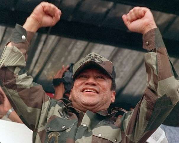 Panamanian military strongman Gen. Manuel Antonio Noriega raises his fists to acknowledge the crowd cheers during a Dignity Batallion rally in Panama City on May 20, 1988. U.S. pressure to force Noriega out of power had so far failed. (AP Photo/John Hopper)