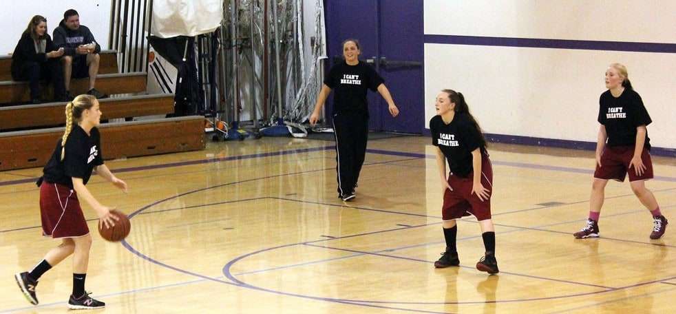 This photo provided by the Fort Bragg Advocate-News shows Mendocino High School girls basketball wearing the "I Can't Breathe" T-shirts before a recent game. A high school basketball tournament on the Northern California coast has become the latest flashpoint in the ongoing protests over police killings of unarmed black men after a school was disinvited because of concerns its players would wear T-shirts printed with the words "I Can't Breathe" during warmups. The athletic director at Fort Bragg High School informed his counterpart at Mendocino High School this week that neither the boys nor girls team would be allowed to participate in the three-day tournament hosted by Fort Bragg High starting Monday, Mendocino Unified School District Superintendent Jason Morse said. (AP Photo/Fort Bragg Advocate-News, Chris Calder)