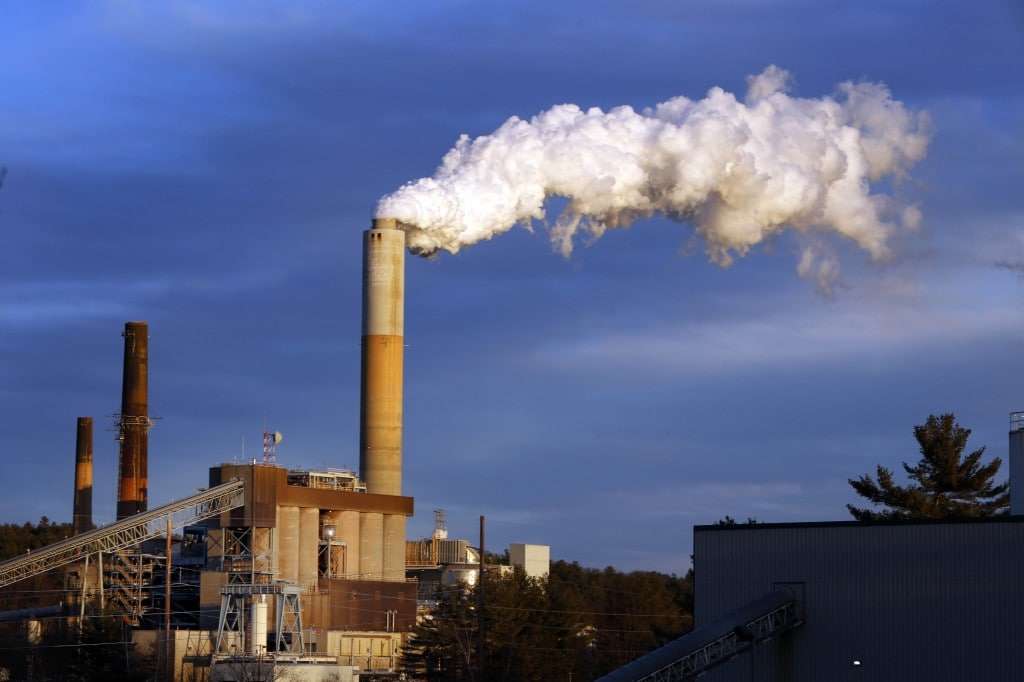 a plume of steam billows from the coal-fired Merrimack Station in Bow, N.H. New Hampshire’s largest utility, Eversource Energy, announced Thursday March 12, 2015 that it has has agreed to sell its power plants. Eversource will sell its nine PSNH hydro facilities and three fossil fuel plants, including the Merrimack Station in Bow, Newington Station and Schiller Station in Portsmouth. (AP Photo/Jim Cole, File)